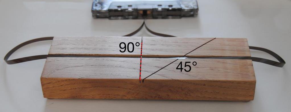 Position the border of the damaged and non-damaged tape over the 90 degree cutting slot.