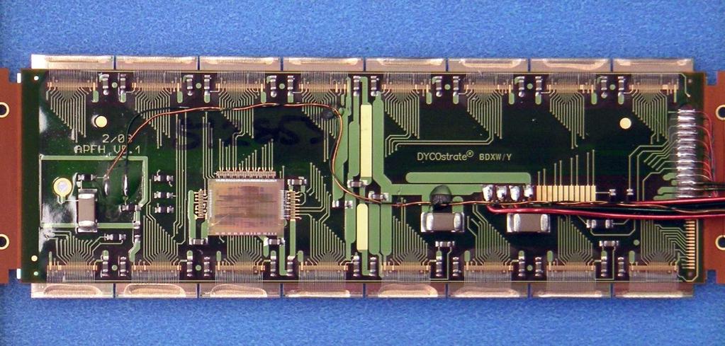 (a) (b) Figure 1.10: (a) The back side of the pixel module with MCC. (b) The FE side of the pixel module, 16 FE chips are connected to a single n + -in-n silicon sensor.