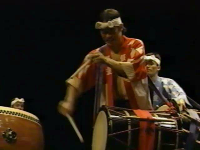 Figure 52. Leonard Eto playing the katsugi-okedō-daiko in "Irodori" Screenshot from a 1992 VHS.