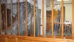 greeted by the presence of an impressive three-manual pipe organ entirely enclosed in one very large chamber with glass swell louvers allowing one to view the pipe work even when the shades are