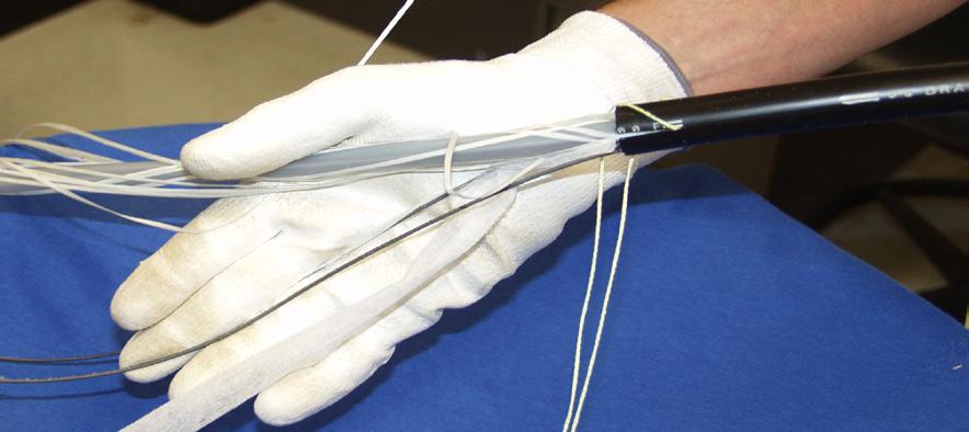 Use snips to cut and remove all excess length of yarns and tape from the cable core.