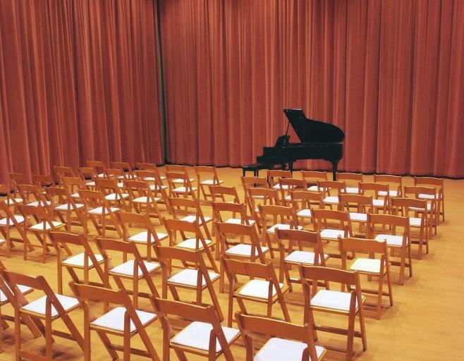 concerts, seminars and performances, and 225 for receptions. It is surrounded by seafoam green acoustical draperies and has a maple floor.
