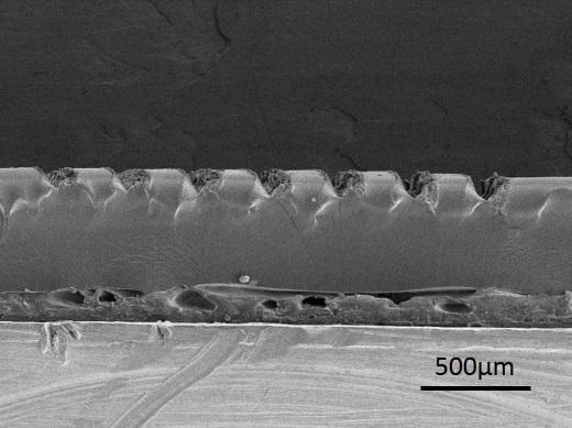Supplementary Figure 3. Groove depth dependence on the laser fluence. Cross-sectional SEM image of gratings fabricated on elastomeric substrate with different Fs laser fluence.