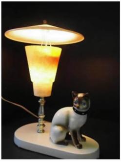 Imagine a lamp with a circular marble base, a vertical 10 inch tall brass rod (containing wires) inserted off center on the base, a light bulb fixture emerging from the top of the brass rod, and a