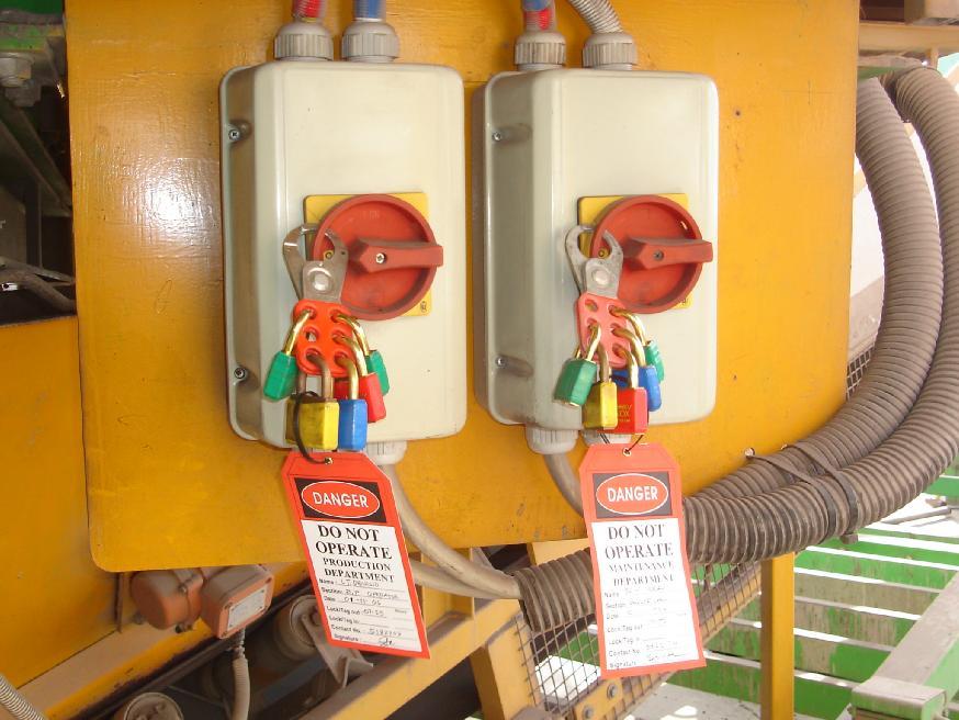 View from Operators cabin showing Isolating Circuit Breakers with multi locks in place, note the color coding there are 2 Green, 1 yellow, 1 red and 1 blue which means there are 2 general workers
