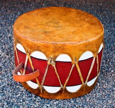 The controlled the sound pitch of the drum by how tightly the stretched