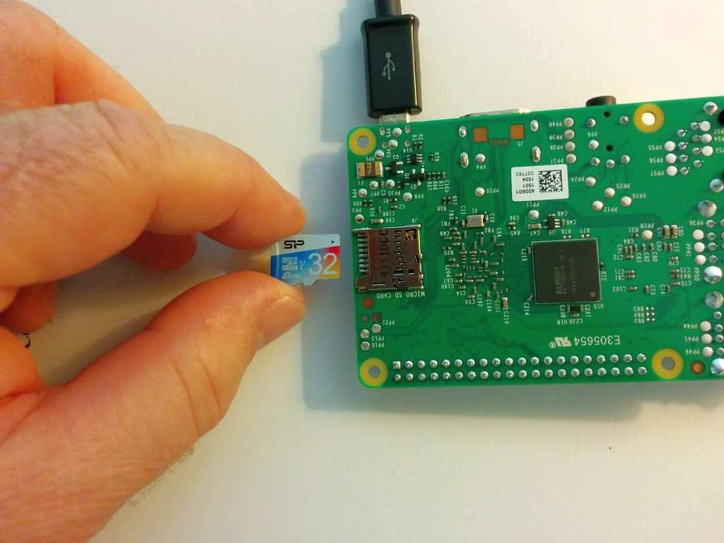 into the rpi ( Figure 2: Inserting SD Card into rpi and Figure 3: SD Card Inserted into rpi).