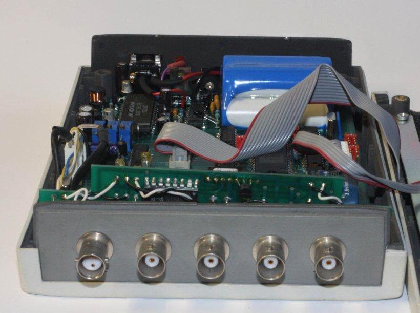 Figure 3 showing the interior of the 8530A with the cover removed. RV1 is located behind the vertical PC board. DO NOT ATTEMPT TO ADJUST THE THREE POTENTIOMETERS ON THE HORIZONTAL BOARD.
