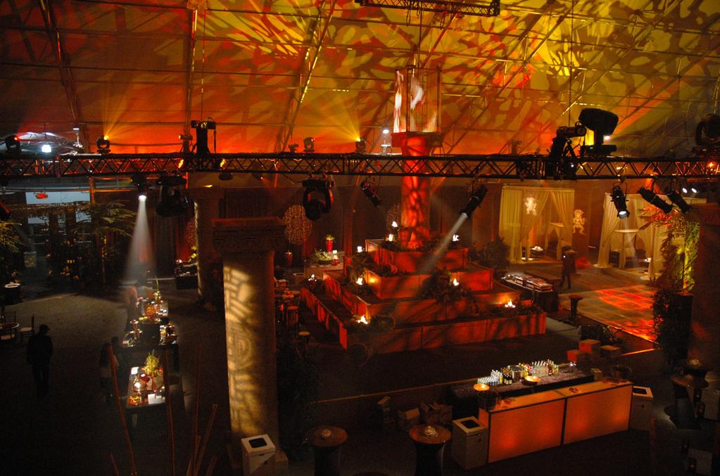 (50) LED uplights used in conjunction with media server to make walls flicker as if lit by center flame. (48) conventional fixtures for various gobo and pattern projections.