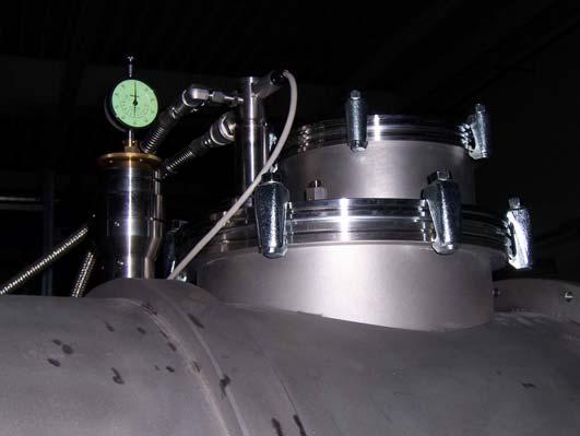 Figure 6 shows the helium and nitrogen port of the cryostat. The photo was taken in November during the vacuum and N 2 cooling tests, when the cryostat was not connected to the He pipeline. Fig.