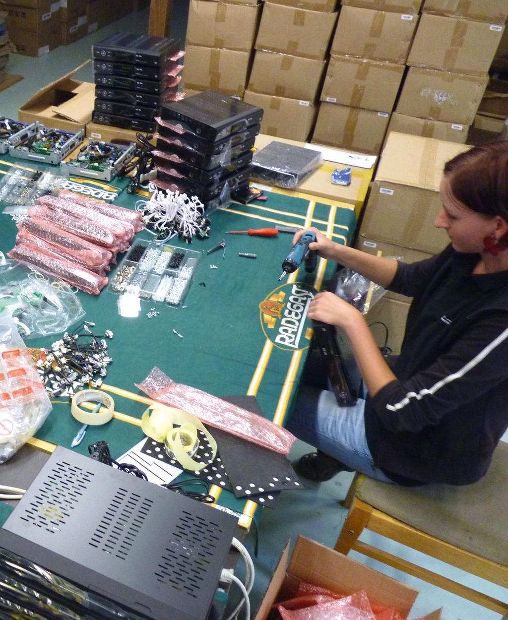 A production employee tests the function of a just-assembled receiver.