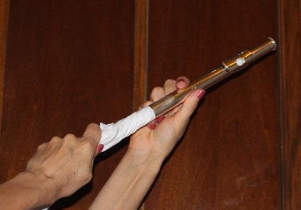 To remove moisture from your flute: 1. Take a corner of your swab pull it through the slit of your cleaning rod.