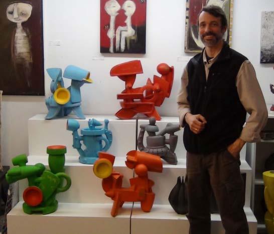 54 Above: Doug Herren with his sculptural ewers and teapots at the Snyderman- Works Gallery. Stoneware with bronze glaze, enamel paint. Photo by Austin Wieland Right: Industrial Teapot, 2012.