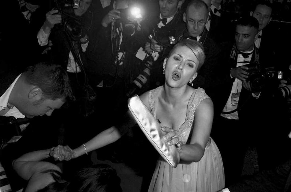 This photograph is so Old Hollywood to me, like a scene from La Dolce Vita scarlett johansson She was leaving a première at Cannes on May 12, 2005, when the press mobbed her.