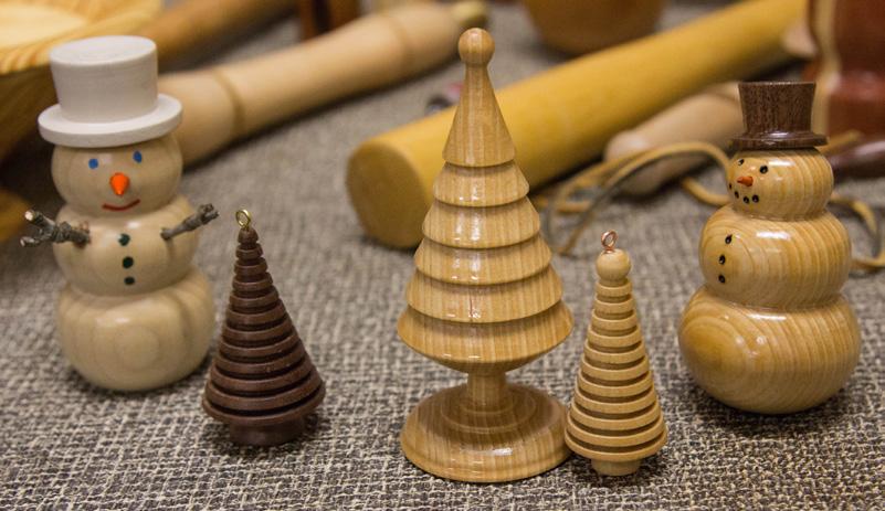 Steve Langrall showed a pair of Zebrawood shakers, Cypress ornaments, a Poplar apple, a Walnut whistle, and a staved Cypress and 2x4 board bowl.