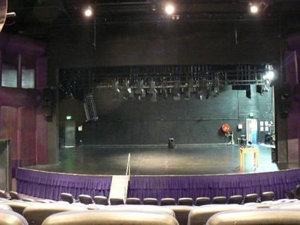 STAGE Raked stage with proscenium arch and single purchase counterweight flying system. Hardwood floor covered in weathertex sheeting.