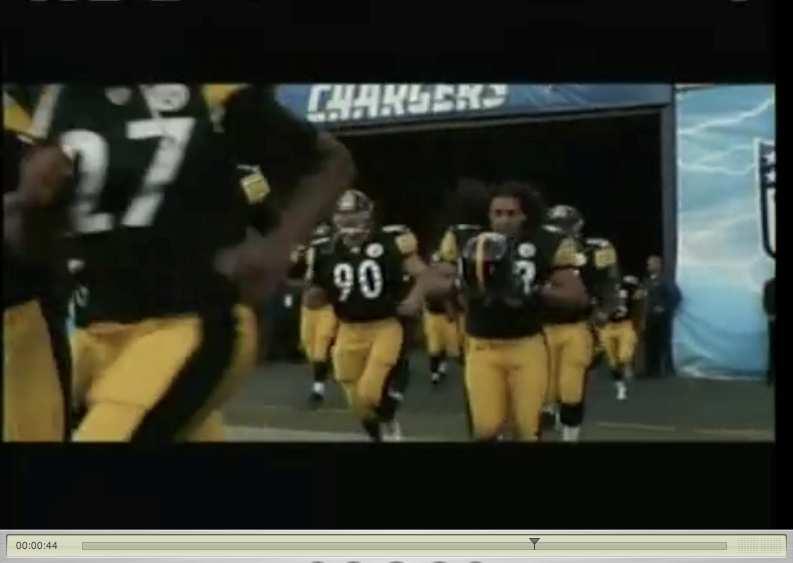 Scene 23 Shot 2 Character (B) Polamalu s team running into the football field at stadium (Pittsburgh Steelers). Music: nondiegetic. Sound elements: Cheering.