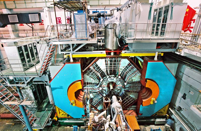 instruments, masks, vacuum pumps, and the BESIII (BEijing Spectrometer) detector co-exist in a crowded space. A special pair of superconducting insertion magnets, the SIM s, is placed in the IR.