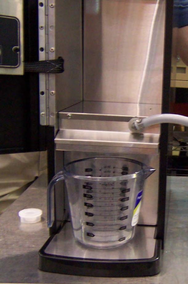 Fig. 3 Place an empty container in the dispense area of the machine as shown in