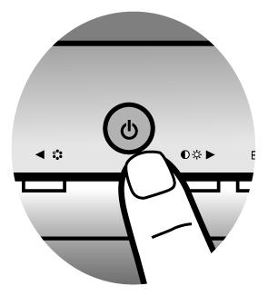 Turn on the monitor by pressing the power button on the front of the monitor.