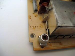 Remove the 5 pins using your de-soldering tool so that the holes are open as in the picture below.