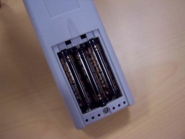 The battery cover is removed by pushing lightly on the recess and sliding the cover downwards.
