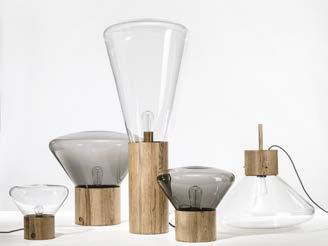 THE LIGHTS, FEATURING A BILLOWING GLASS SHADE SET IN A HANDCRAFTED WOOD BASE