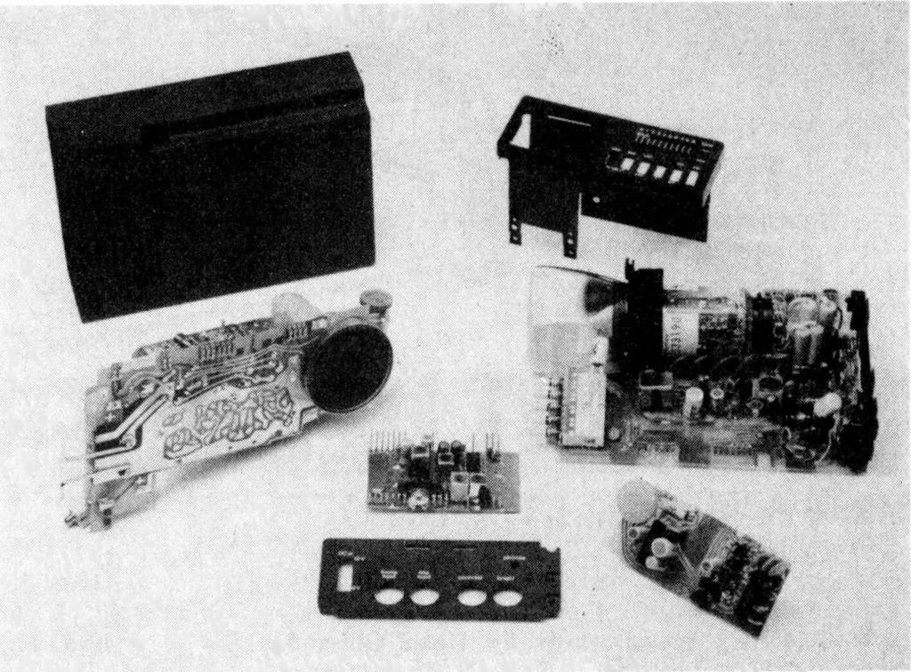 Photograph showing the modular construction of the Sinclair Microvision pocket TV set. The four printed circuit boards and case sections are as follows, from left to right.