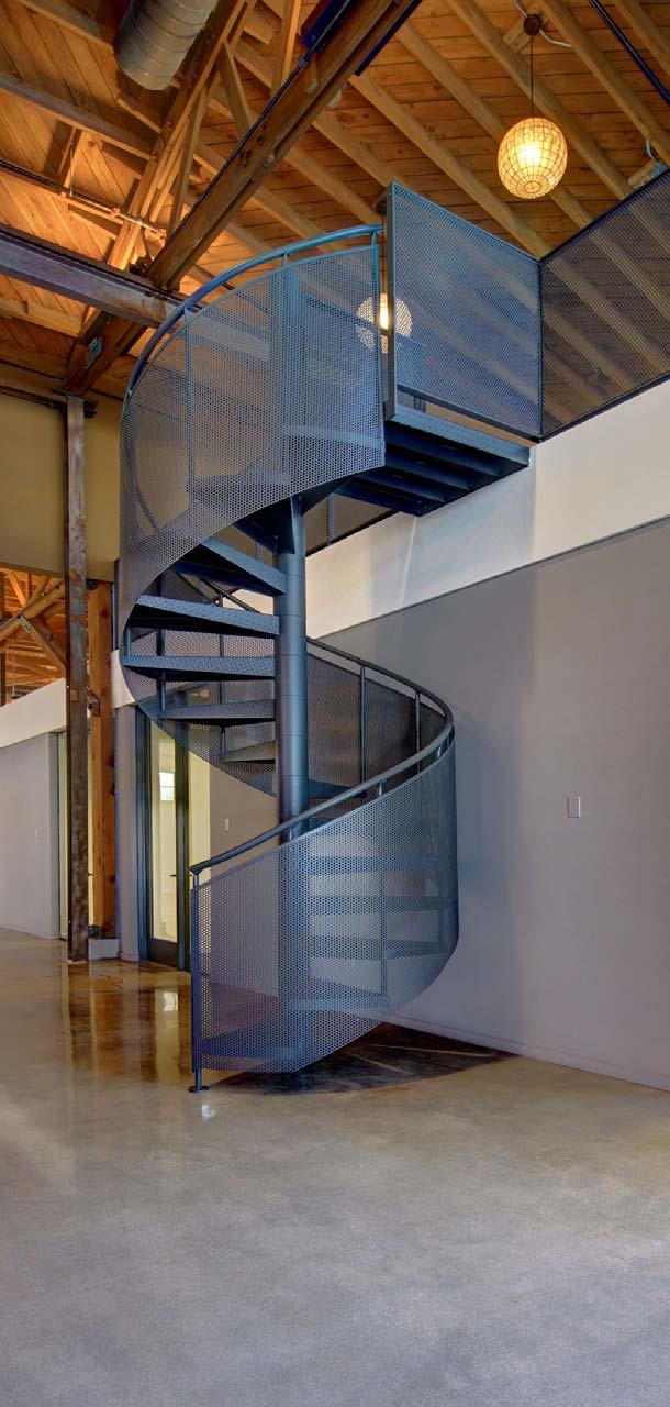 Custom designed circular steel stairs lead to 2nd level meeting areas im pres sive /im presiv/ In Zen tradition, the private entry courtyard is flanked by two 10 high bi-fold glass door systems and a