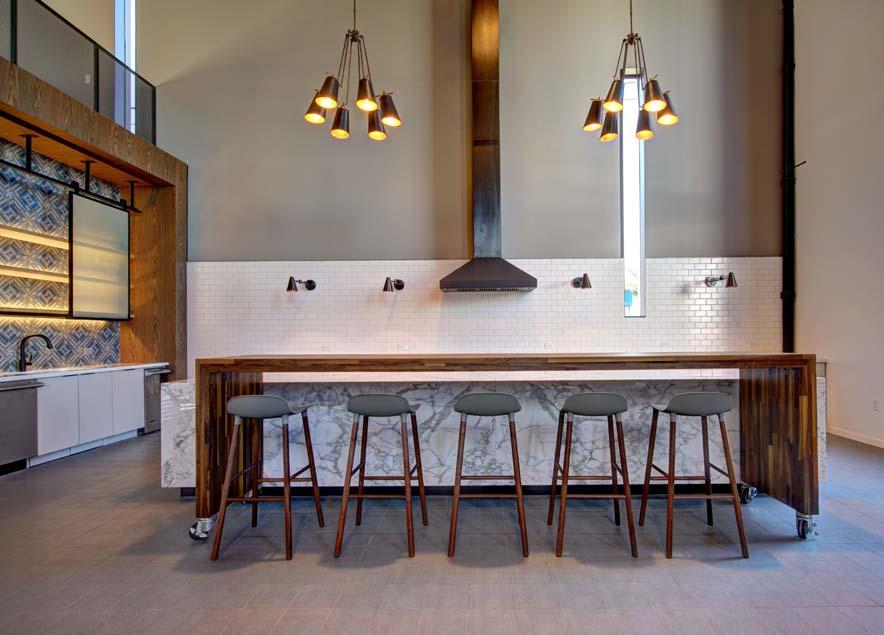 Carrera marble stone tops, 12 walnut table and built-in banquette seating adorn the kitchen.
