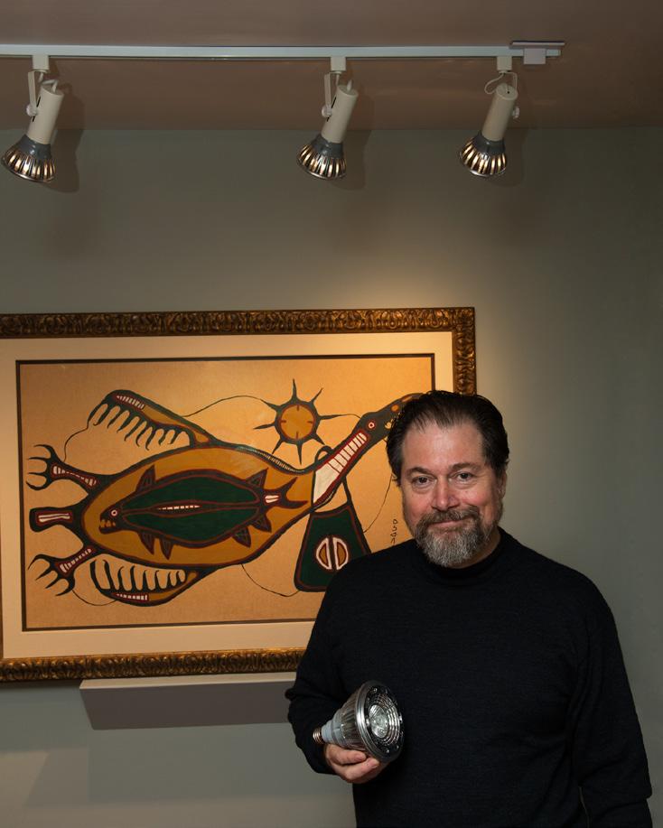 Figure 3 Mr. John Newman, holding a PAR30 bulb in front of Norval Morrisseau s Mythical Thunderbird FILAMENT RATTLING AROUND...IF YOU JUST MOVED A LAMP, YOU D HAVE TO TAKE IT DOWN VERY GENTLY.