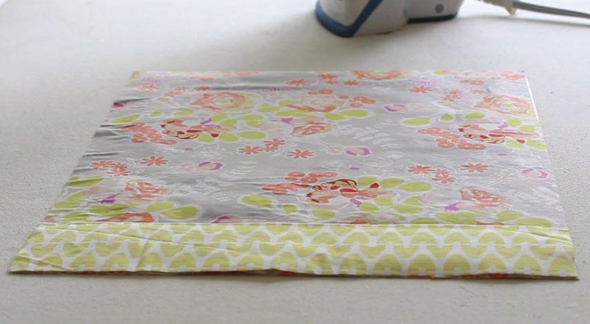 If adding a contrasting fabric to the spine: Take the spine fabric and fold over 1/4 of the long side and press.