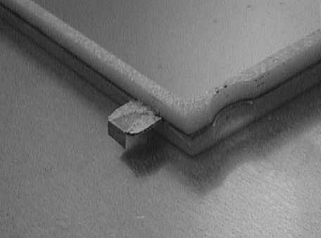Since the drift plane is confined completely by the frames, a small triangular piece has to extend out of the sealed volume to enable HV connection to the drift cathodes using conductive glue.