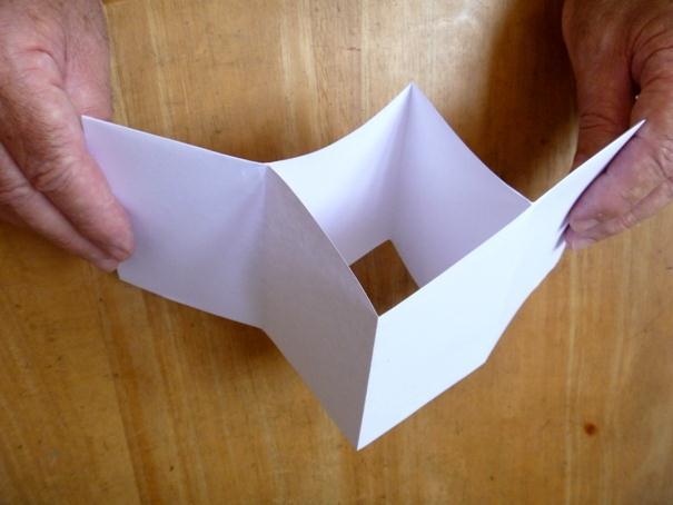 Slide 9 Open the paper, and re-fold it the other way keeping the same side of the paper on the outside.