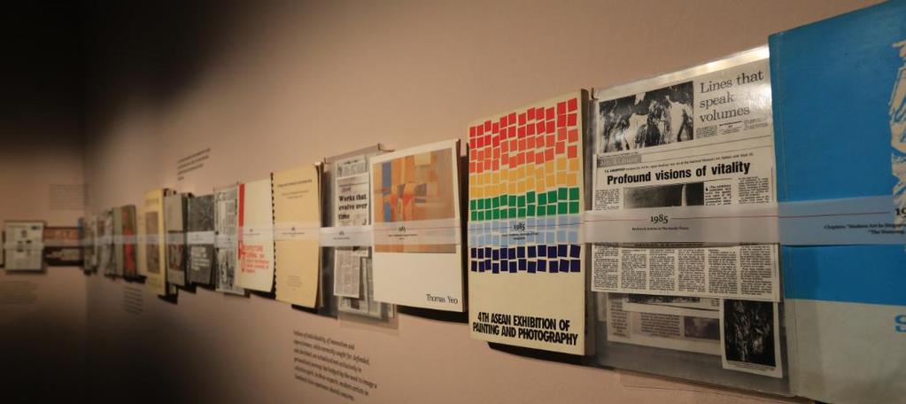 23. Proceed deeper into the gallery and stop at an installation with books mounted on the wall.