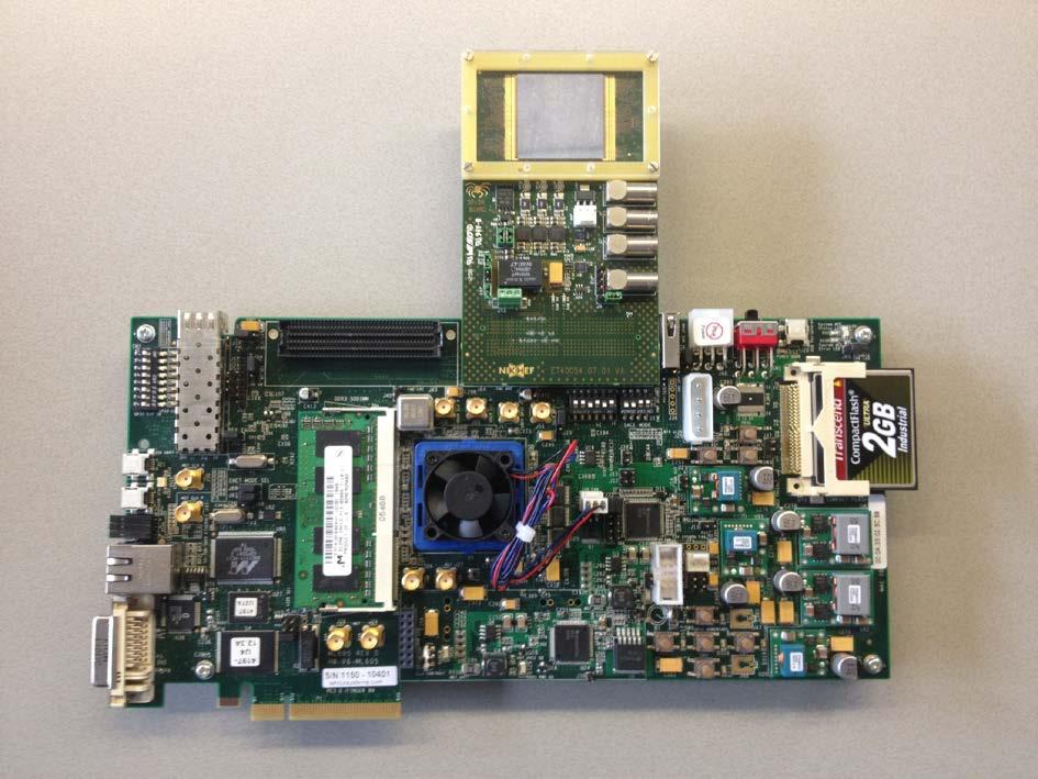 Below there is a picture of the Xilinx Virtex-6 ML605 Evaluation board with on the top side an extension board that can carry up to four read-out chips, which are read out in parallel.