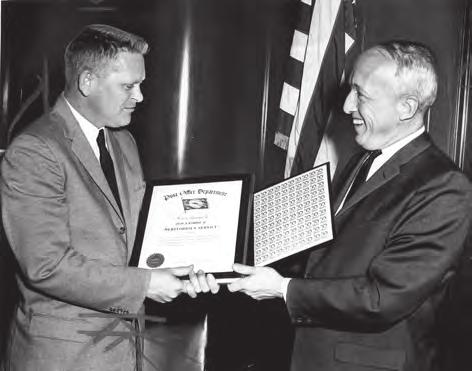 Frank J. (Jim) Crawford (left), designer of the Christmas stamp, received the Post Office Department s meritorious service award from Postmaster General Day. (Post Office Department Photo.