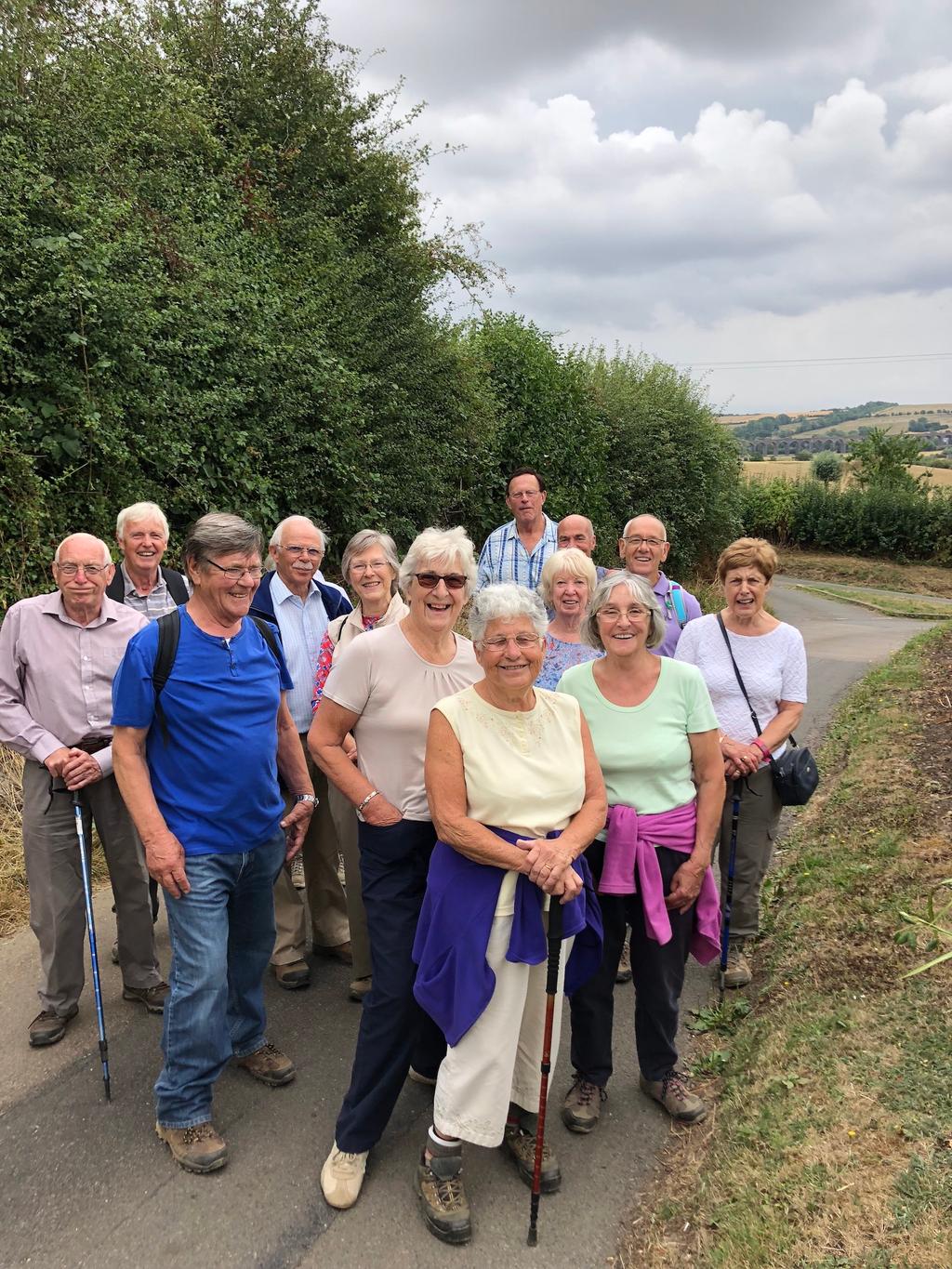 Bev Sabin 01455 283379 GROUPS Walking 2nd Thursday This picture features members of the walking group on the August walk from Lyddington the photo is in Seaton with Harrington viaduct in background.