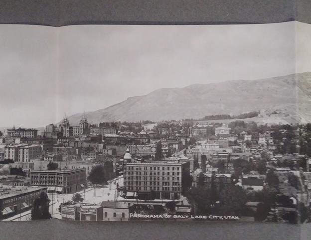 Twenty-four tipped-in Albertype photographs mounted on thick gray leaves. One large folding panoramic photo of Salt Lake City, measuring 26.5" x 7".