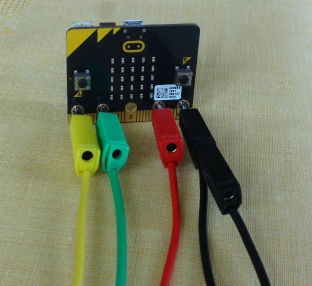 The experiments use a temperature sensor, a light sensor, a buzzer and a triple set of LEDs. Connections are made to the pin sockets on the micro:bit using leads with 4mm plugs.