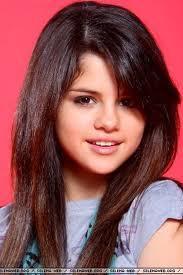 She is Selena Gómez She is 21 year old She is from USA She has long black hair.