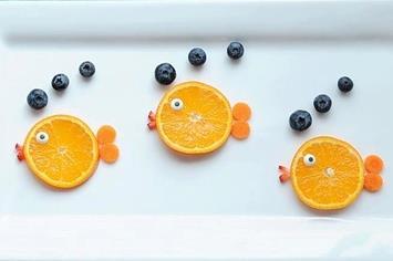 carefully place each fruit to make FUNNY FRUIT FACES.