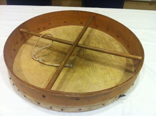 It is a small handheld drum about 35-45 inches wide with a head made
