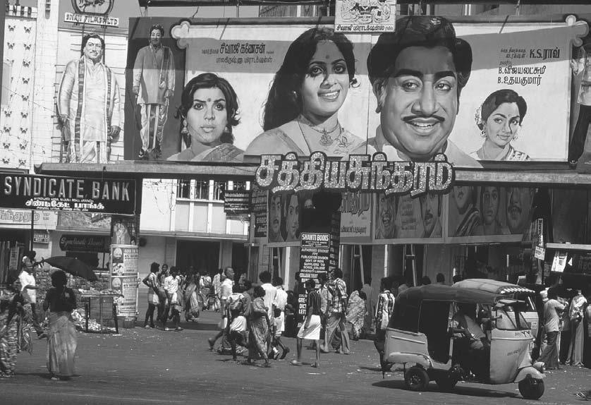 214 POP CULTURE INDIA! A giant billboard advertising a movie stands on a street in Madras, ca. 1985 1995.