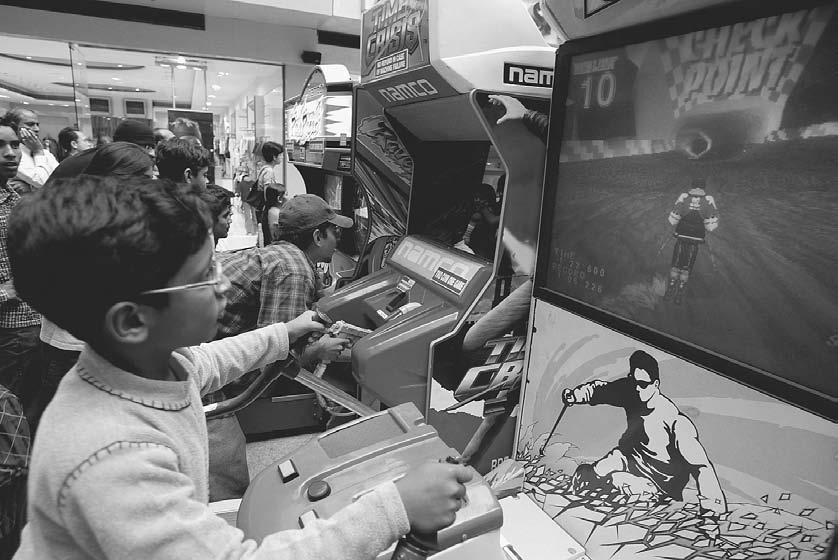 CONSUMER CULTURE 279 Children play video games at an arcade in a mall in Gurgaon, Haryana, outside New Delhi.