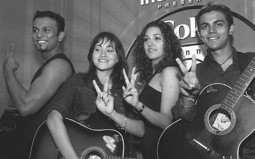 MUSIC 21 From left to right, Jimmy Felix, Vasudha Sharma, Neeti Mohan, and Sangeet Haldipur, members of the musical group Popstars 2, flash a victory sign as they pose in New Delhi 16 September 2003.