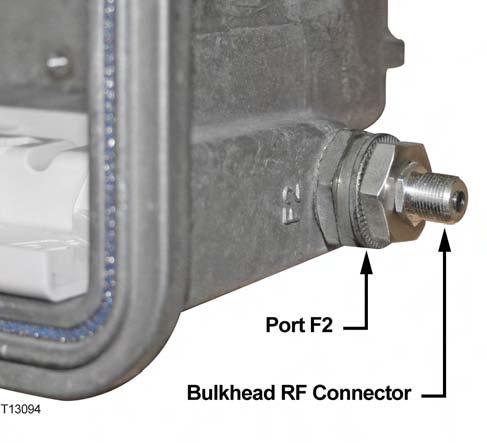 5 Thread the bulkhead RF connector assembly into port F2 on the node housing lid as shown in the following illustration.
