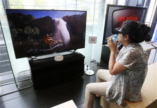 In this Tuesday, June 19, 2012 photo, a visitor watches Samsung Electronics Co.'s 3D television in a showroom at Samsung Electronics Co.