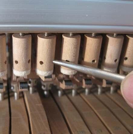 Adjustment of the repetition springs. Each note has a spring which helps the action to "reload" before the next note.