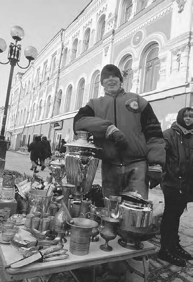 CONSUMER CULTURE 317 Moscow, 1992. A street seller selling souvenirs on the Old Arbat Street in Moscow. (Photo by Andrey Golovanov/Kommersant) painted or hand printed.